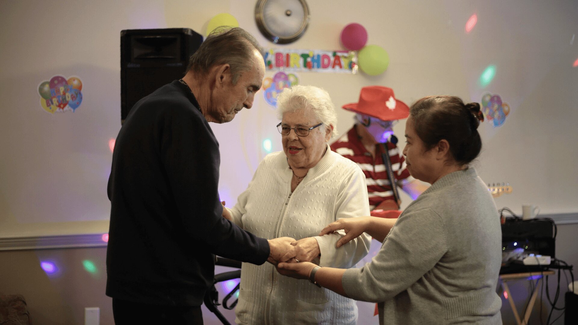 An elderly couple dance together at community event at RCG